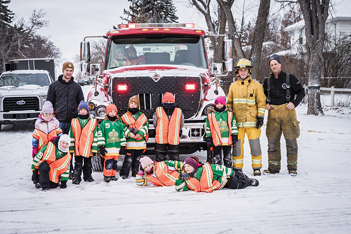 Some of the minor hockey players and firefighters during the food drive in Kipling before Christmas.