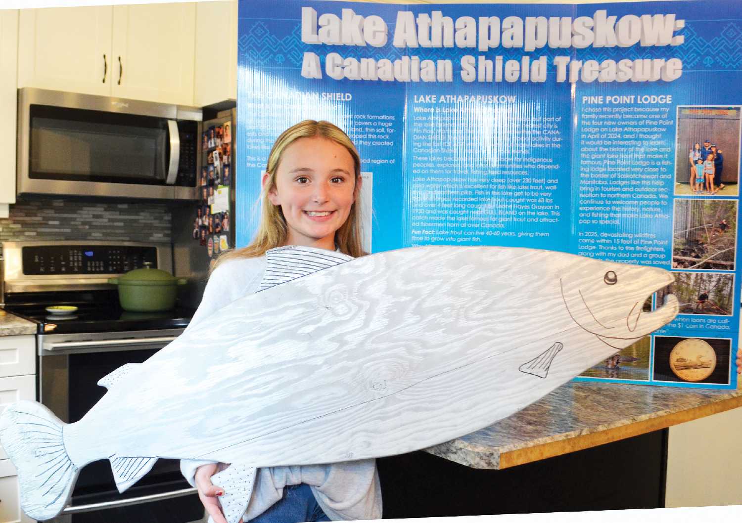 Harli Raiwet of Whitewood has won both at the local Whitewood School level and the provincial level for her Heritage Fair project on Lake Athapapuskow and Pine Point Lodge. She is now in the running for the national title as well. Here, the Grade 5 student holds the wooden fish her and her dad Cole made together.   		